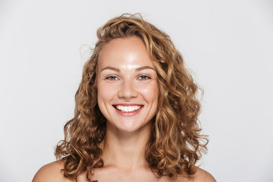 Image of happy half-naked woman smiling and looking at camera