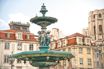 Fototapeta na wymiar Rossio Square with fountain and sculpture, Lisbon