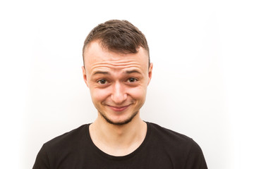 Obraz premium emotion smile, young man in a black cap on a white background, man emoji