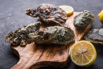 Fresh open Oysters. Healthy sea food. Dinner in restaurant. Gourmet food. Dark background. Top view...
