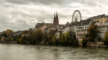 Fototapeta na wymiar Grossbasel old town with Basler Muenster Cathedral on the Rhine river in Basel on a rainy day, Switzerland