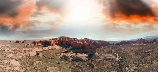 Aerial panoramic view of Arches National Park landscape, Utah. Drone point of view at sunset