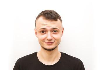 Obraz premium emotion grinning, young man in a black cap on a white background, man emoji