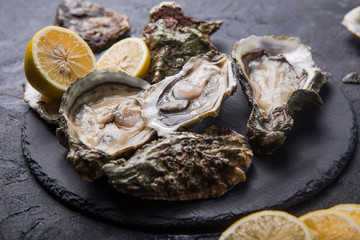 Fresh open Oysters. Healthy sea food. Dinner in restaurant. Gourmet food. Dark background. Top view...