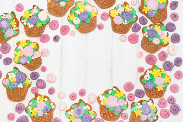 Gingerbread cookies in the form of baskets with flowers on a white wooden background. place for your text. Congratulations on Mothers Day, March 8, spring and others.