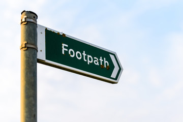Fototapeta premium metal footpath sign over sky background in uk