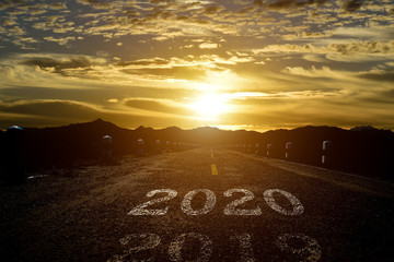 The word 2020 written on highway road at sunset background. Concept for new year 2020.