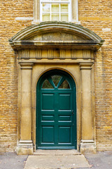 old vintage door on a stone wall in england uk