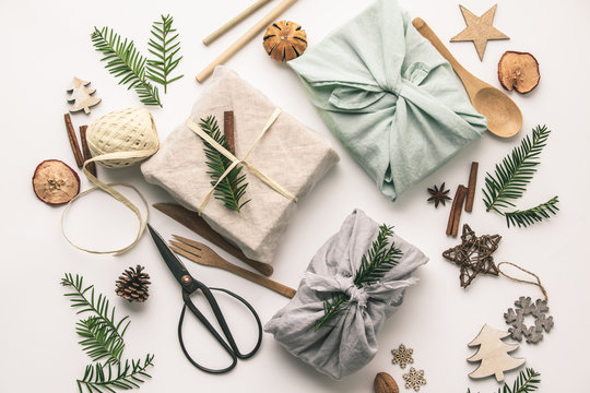 Fabric wrapped gifts and wooden Christmas decorations