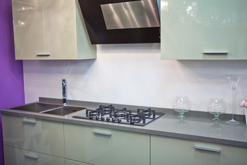 modern kitchen with cooking stove and hood