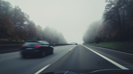 driving on foggy autobahn - obrazy, fototapety, plakaty