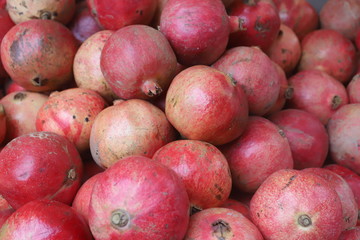 closeup of a hand taking a tomato from a market stall