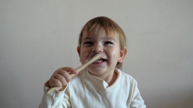 Child girl brushes her teeth with a bamboo toothbrush. zero waste concept