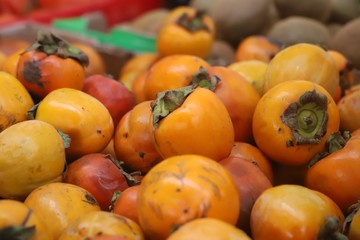 closeup of persimmons on display at the market