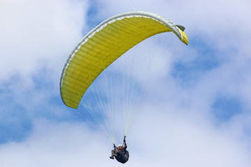 Paraglider flying wing in a blue sky	