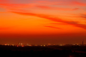 Colorful dramatic sunset sky in an industrial zone of a city.