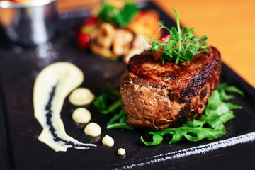 Fototapeta na wymiar Delicious beef steak on a plate, close-up.