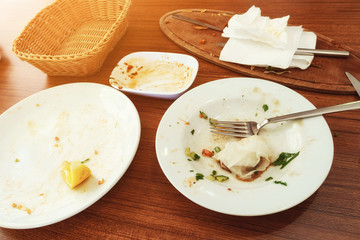 Top view empty dirty white plates or dish on brown wooden table background