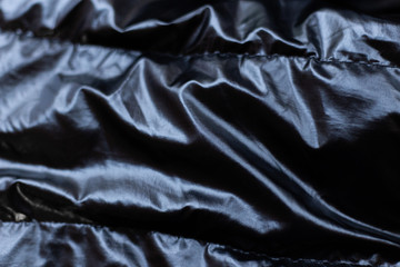 Closeup of crumpled black silk fabric copy space