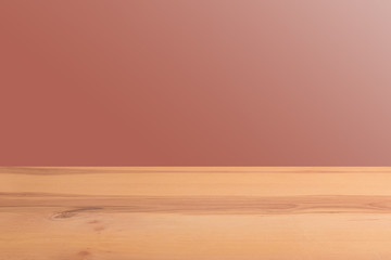 Wooden board table in front of a blurred background. Perspective brown wood with a blurry multi-colored background - can be used to showcase or assemble your products. Mock up to display the product.