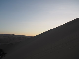 Fototapeta na wymiar View of the dunes after the sun has set and the light has dimmed, Oasis of Huacachina, Atacama Desert, Ica, Peru