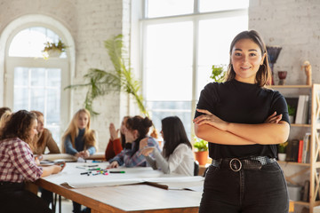 Women's rights and equality at the office. Caucasian businesswomen or young confident model crossed hands in front of coworkers having meeting about problem in workplace, male pressure and harassment.