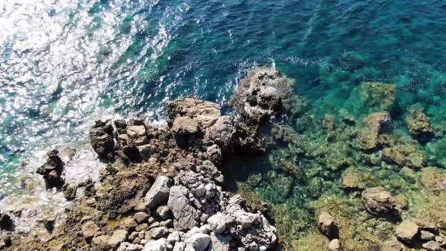 Georgeous Clear Water In Menorca Smooth Waves On The Rocks - Aerial Shot