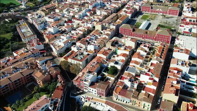 Flying over the small village with a port of Es Castell in Menorca Spain
