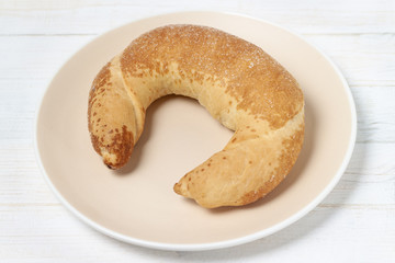 Croissant with ceramic plate wooden wood light white background