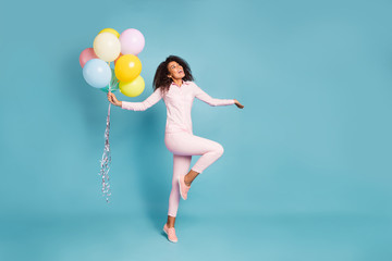 Fototapeta na wymiar Full length photo of amazing wavy dark skin lady holding many air balloons excited positive party mood wear pink shirt trousers isolated blue color background