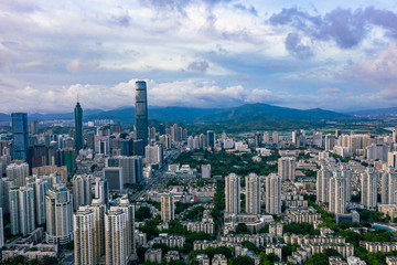 an aerial view of summer sunrise in shenzhen china, with hills in hong kong at the background