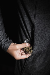 Obraz premium young man with a bag of marihuana buds