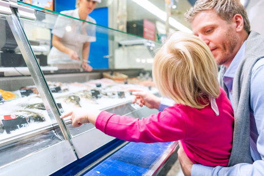 Family At The Fish Counter In A Supermarket