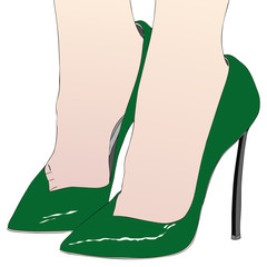 The sexy feet of a woman in sensual high-heeled green shoes