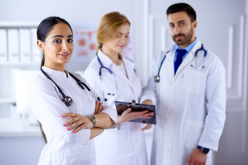 Attractive female arab doctor in front of medical stuff in hospital