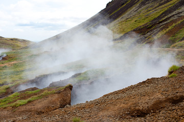 Hot Spring Hiking and Natural Bathing in Geothermal Hot River Reykjadulur, Iceland, Europe.