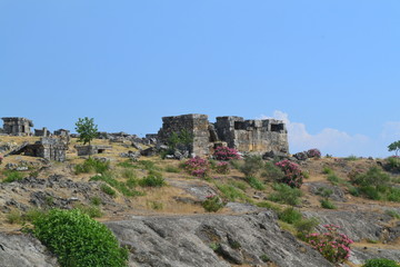 Fototapeta premium Old Hierapolis ruins, amphitheatre and touristic locations captured with hill background, in daytime.
