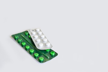 Pills in blister packs on a light background. Medicines for diseases.