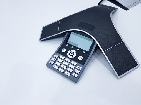 Business conference phone set up in the meeting room. Communication technology for voice conference meeting for long distance office or workplace