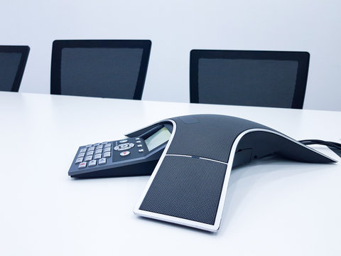 Business conference phone set up in the meeting room. Communication technology for voice conference meeting for long distance office or workplace