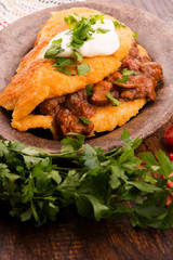 Potato pancakes with meat, vegetable, tomato and parsley
