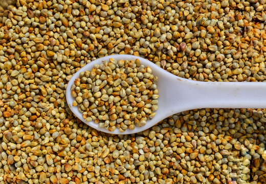 Millet in spoon above bowl, top view bajra,Healthy bajri Millets Close up View - Image,top view of Millet