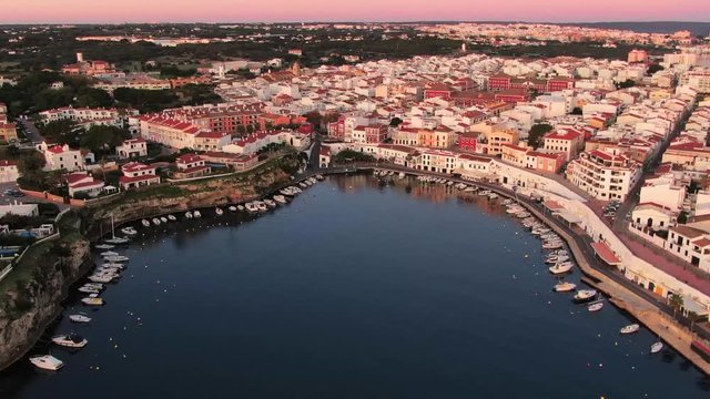 Up cenital flight over the small port village of Es Castell in Menorca Spain