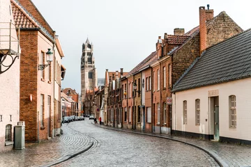 Gordijnen Smalle Straten Ancient streets of the old city of Brugge in Belgium. An empty street from a lumber block extending into the distance in rainy weather.  © Елизавета Завьялова