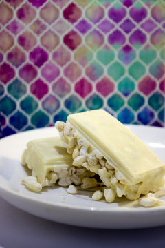 Rice Krispies, Puffed Rice With White Chocolate On A White Plate On A Colourful Background