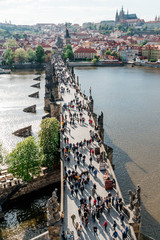 Top view on Charles Bridge Prague. A lot of tourists walking along the Charles Bridge.