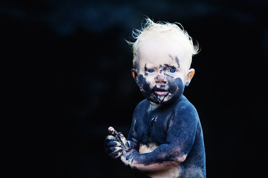 Funny Portrait Of Happy Smiling Child With Dirty Face, Hands Playing With Fun On Black Sand Beach In Sea Water Pool Before Swimming. Family Lifestyle Active Leisure On Summer Vacation With Little Baby