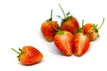 Strawberries are laid on a white background.