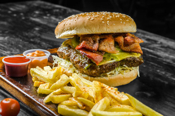 Cheeseburger, french fries and soda glass