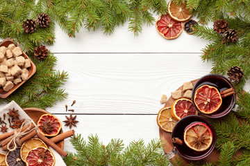 Ingredients for mulled wine and christmas tree branches on white background as template for a...